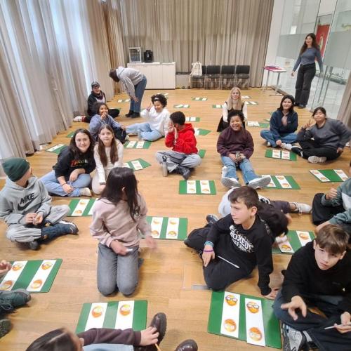 Kinder sitzen am Boden und lernen